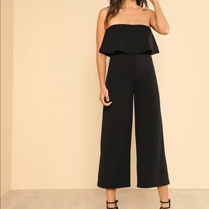 Black capri length romper with overlay.